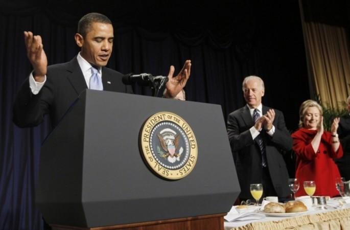 President Obama (L-R) is applauded by Vice President Biden and Secretary of State Hillary Rodham Clinton during the National Prayer Breakfast at a Washington hotel Feb. 4, 2010.