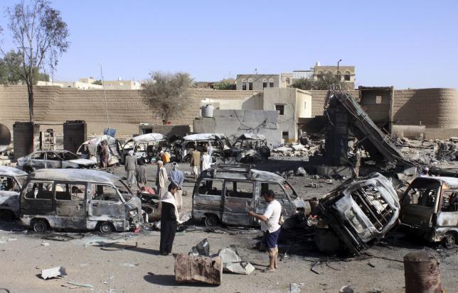 Burnt-out vehicles are seen at a gas station after it was hit by an air strike in Yemen's northwestern city of Saada, April 16, 2015.