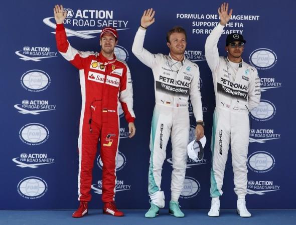 Mercedes driver Nico Rosberg (C) celebrates his pole position next to his team mate Lewis Hamilton (R) and Ferrari's Sebastian Vettel after the qualifying session of the Spanish Grand Prix at the Circuit de Barcelona-Catalunya. Spanish Grand Prix