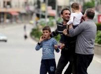A man reunites with his family members after they were rescued by the police near a police checkpoint in Kumanovo, Macedonia May 9, 2015.