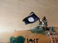 Isis fighter waves black flag of Islamic State