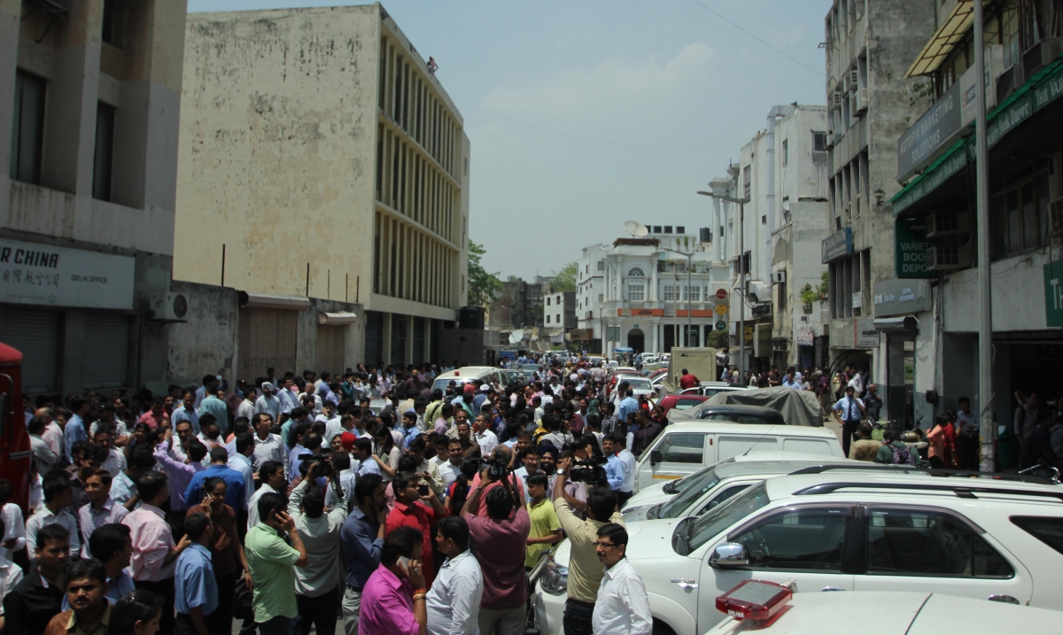 People rush out of their offices as earthquake jolts Delhi on May 12, 2015. Delhi Earthquake