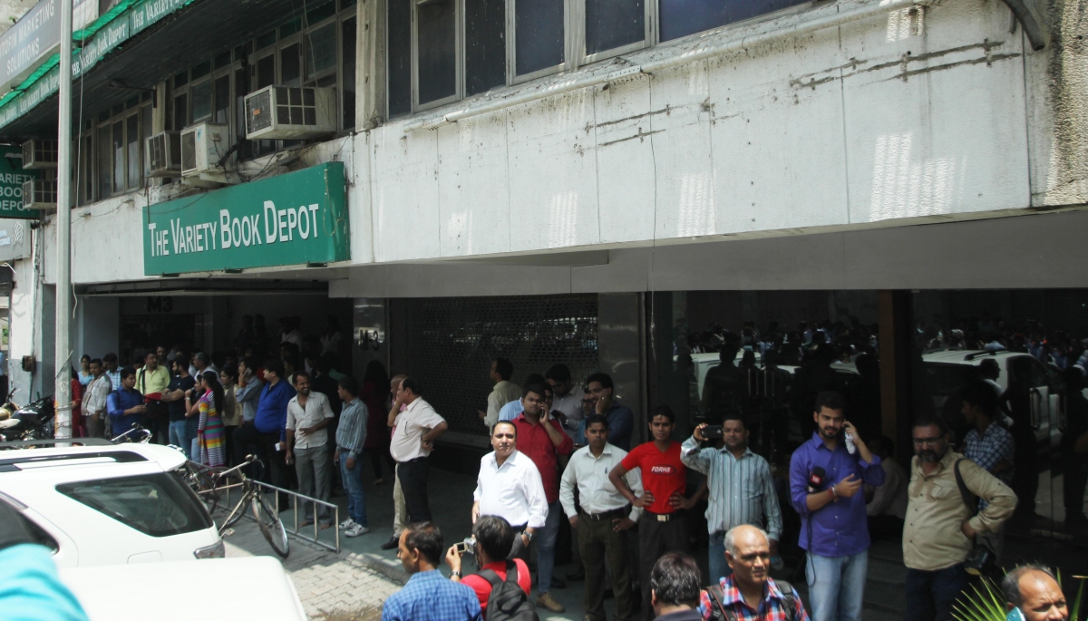 People rush out of their offices as earthquake jolts Delhi on May 12, 2015. Delhi Earthquake