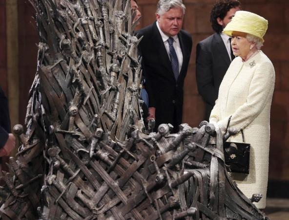 'Game of Thrones' and the Royal Fascination: Britain's Queen Elizabeth looks at the Iron Throne next to 'Game of Thrones' cast members Kit Harington, Conleth Hill and Lena Headey, on the set of the television series in the Titanic Quarter of Belfast, Northern Ireland, June 24, 2014. Queen on the sets of Game of Thrones
