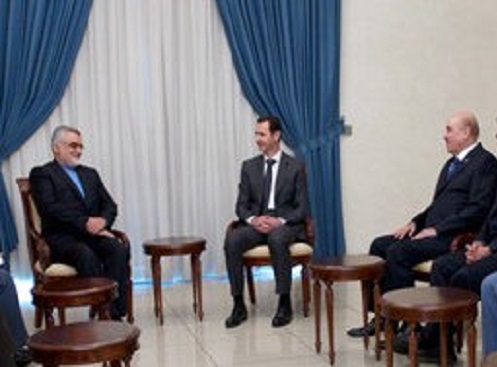 Syrian intelligence chief, Ali Mamlouk (right) made his first public appearance after rumours of a coup. In his video grab he is seen with President Assad (Centre) and Iranian Shura Council's Committee for Foreign Policy and National Security Alaeddin Bo
