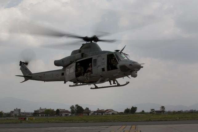 A UH-1Y Huey helicopter flies into the Tribhuvan International Airport after a search and rescue operation in Kathmandu, Nepal, May 13, 2015.