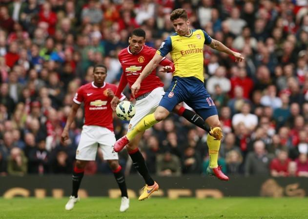Manchester United defender Chris Smalling and Arsenal striker Olivier Giroud fight for possession during their English Premier League game Chris Smalling Manchester United Olivier Giroud Arsenal
