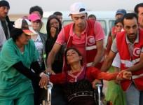 Members of the Kurdish Red Crescent helping a Yazidi woman