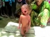 A witch doctor forces a 2-day-old baby to walk in Assam