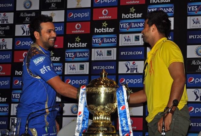 File photo: Mumbai Indians' Rohit Sharma and Chennai Super Kings' Suresh Rain pose with IPL trophy in 2015. Rohit Sharma Mumbai Indians Suresh Raina CSK