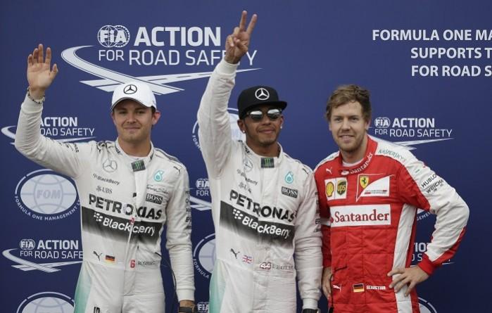 Mercedes driver Lewis Hamilton (C) celebrates his pole position next to his team mate Nico Rosberg (R) and Ferrari's Sebastian Vettel (left) after the qualifying session of the Monaco Grand Prix at the Circuit de Monaco. Monaco Grand Prix