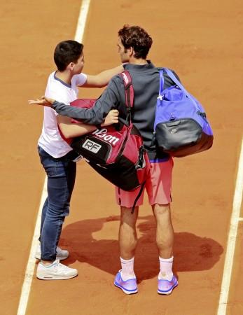 Roger Federer was startled as a young fan found his way to the centre court for a selfie. Roger Federer