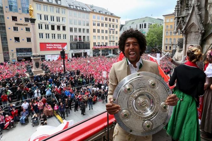 Bayern Munich defender Dante celebrates with the Bundesliga trophy Dante Bayern Munich
