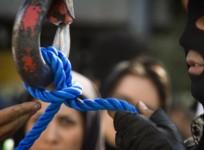 An Iranian executioner checks the rope before a public hanging.