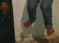 A video grab shows an Isis militant torturing a 14-year old boy