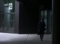 The headquarters of the Deutsche Bank are reflected in the polished floor, in Frankfurt, Germany, April 27, 2015.