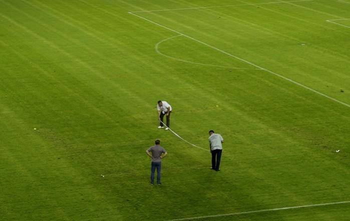 Officials inspect the part of the ground where a swastika symbol was visible Croatia Swastika Symbol