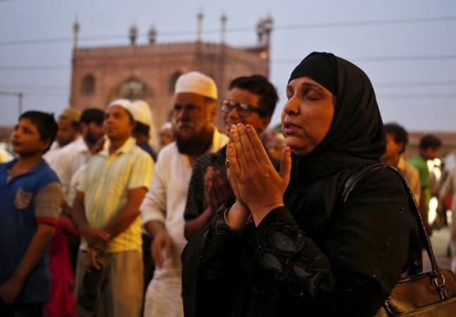 A Muslim woman prays as she and others assemble to spot the crescent moon, on the eve of the holy fasting month of Ramadan at the Jama Masjid (Grand Mosque) in the old quarters of Delhi, India. Ramadan 2015