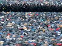 Russian interior ministry members stand guard as Muslims attend an Eid Al-Adha mass prayer in Moscow