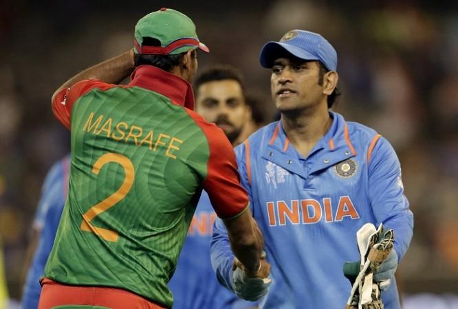 MS Dhoni (R) was seen pushing the Bangladeshi bowler Mustafizur Rahman during their first ODI at Mirpur. MS Dhoni