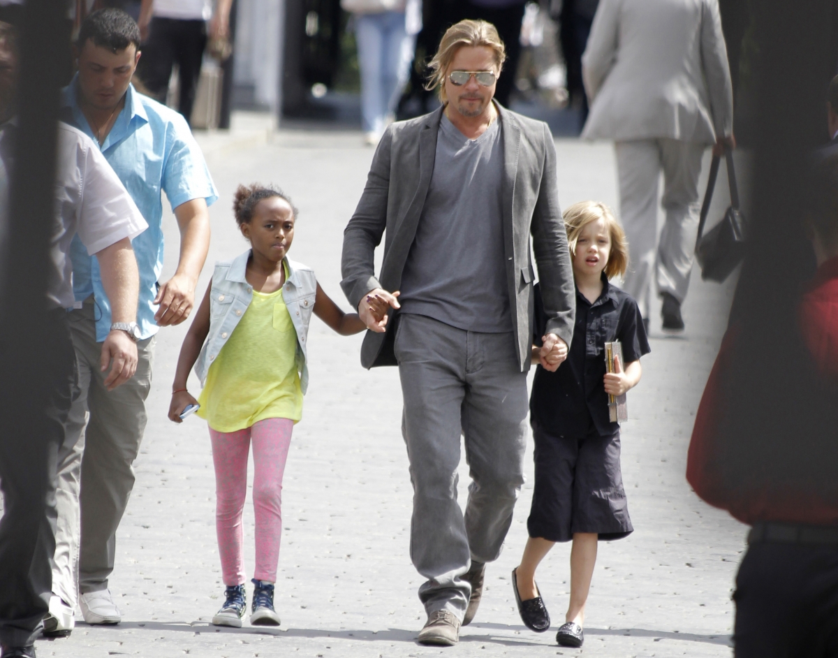US actor Brad Pitt walks with his daughters Shiloh and Zahara near the Kremlin in Moscow, June 20, 2013. Brad Pitt