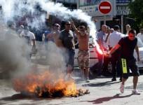 Taxi drivers on strike burn tyres during a national protest against car-sharing service Uber in Marseille, France