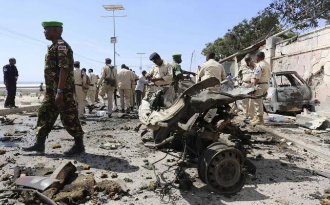 Somalia's army soldiers and peacekeepers from the African Union Mission in Somalia (AMISOM) gather at the scene of an explosion in front of the airport in Somalia's capital Mogadishu, December 3, 2014.