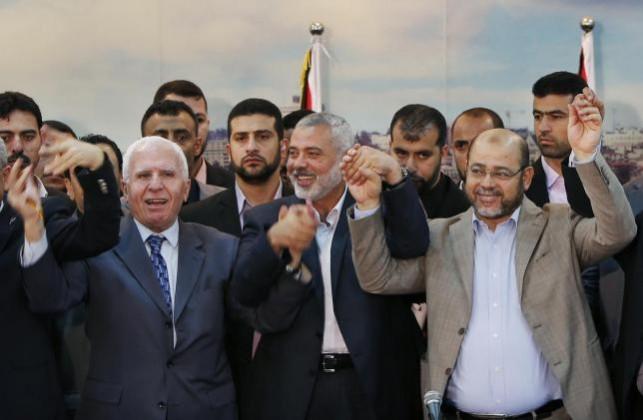 Hamas chief Ismail Haniyeh assassinated in Tehran Senior Fatah official Azzam Al-Ahmed (L), head of the Hamas government Ismail Haniyeh (C) and senior Hamas leader Moussa Abu Marzouq hold their hands after announcing a reconciliation agreement in Gaza City April 23, 2014.