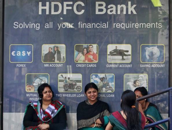 Customers sit outside the branch of a HDFC bank at a shopping arcade in Agartala, capital of India's northeastern state of Tripura, January 20, 2014. HDFC Bank