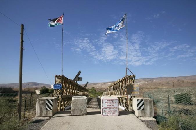 Israel will build a 30 km fence along its border with Jordan to seal-off the country from any attacks by Isis. File image shows Israeli and Jordanian flag on a border between the two countries.