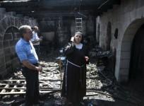 A nun stands at the scene of a fire in the Church of Loaves and Fishes on the shores of the Sea of Galilee in northern Israel June 18, 2015.