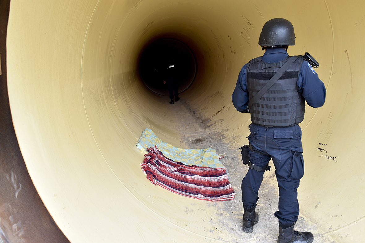 Federal police inspect a pipeline under construction near the Altiplano prison in Almoloya de Juarez
