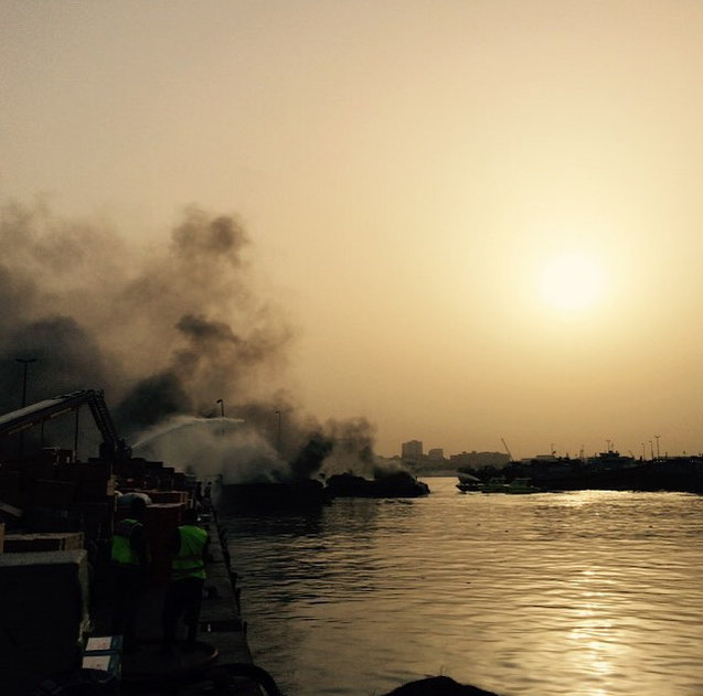 Fire engines spray water on the remains of two boats that were destroyed in an inferno on Monday afternoon.