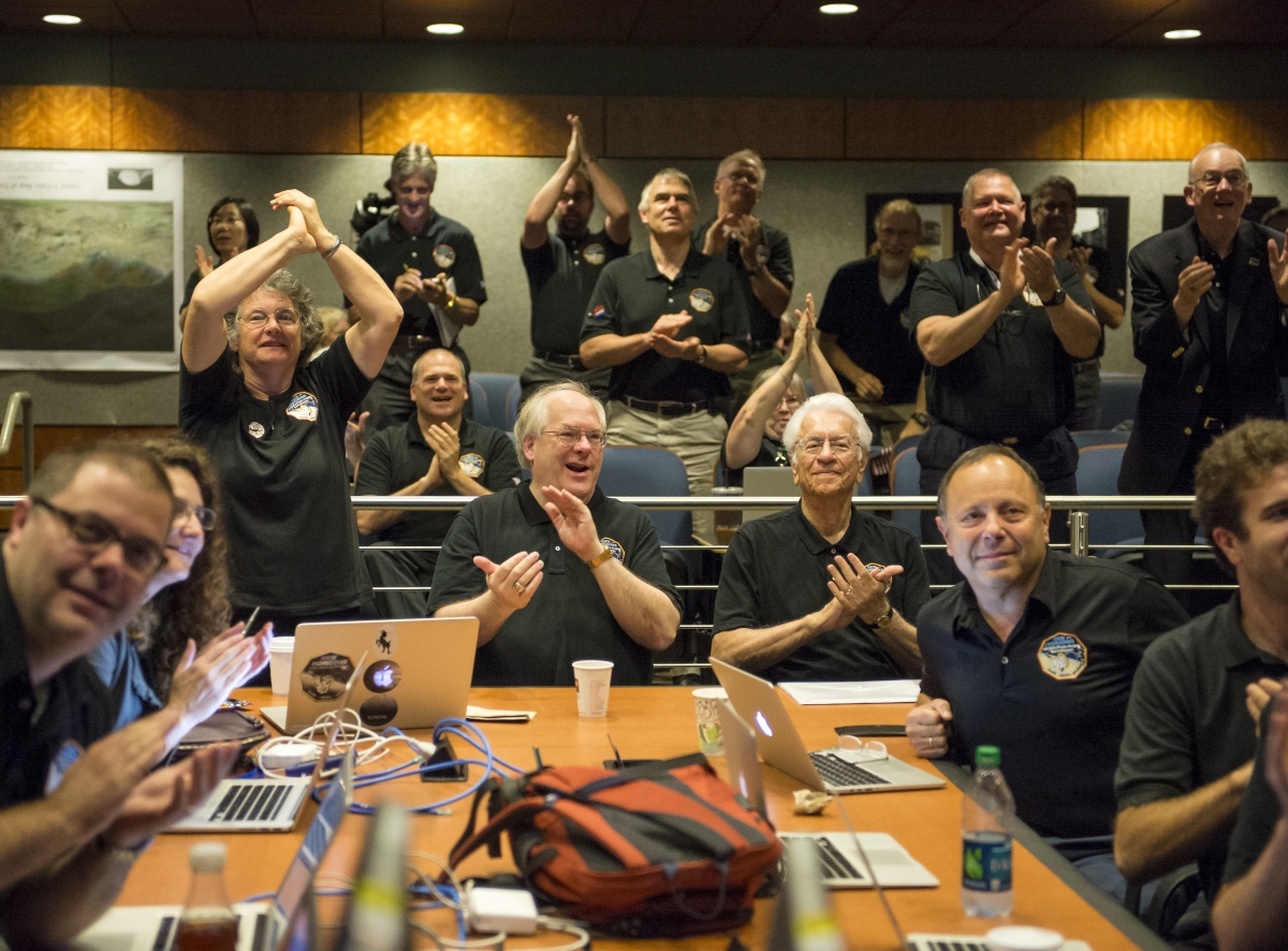 Members of the New Horizons science team react to seeing the spacecraft's last and sharpest image of Pluto before closest approach later in the day celebration of the spacecraft New Horizons flyby of Pluto New Horizons
