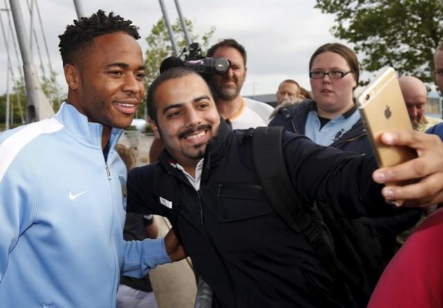 Raheem Sterling looks a happy man after signing a five-year contract with Manchester City sterling Man City