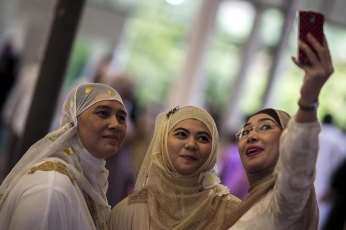 Thai Muslims take a selfie after they attend a mass prayer during Eid al-Fitr celebrations at a mosque in Bangkok, Thailand. Eid al-Fitr 2015