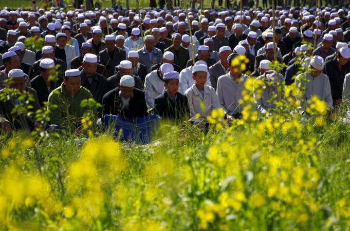 Muslims attend a massive prayer session next to crop fields near a mosque during Eid al-Fitr in Datong county, Qinghai province, China. Eid al-Fitr 2015