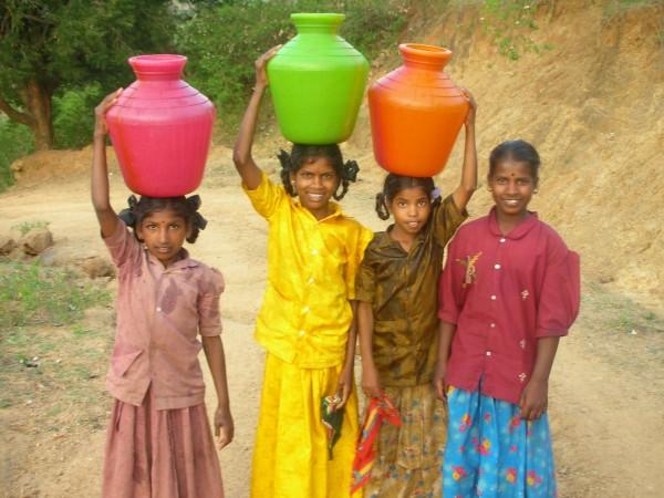 girls carrying water