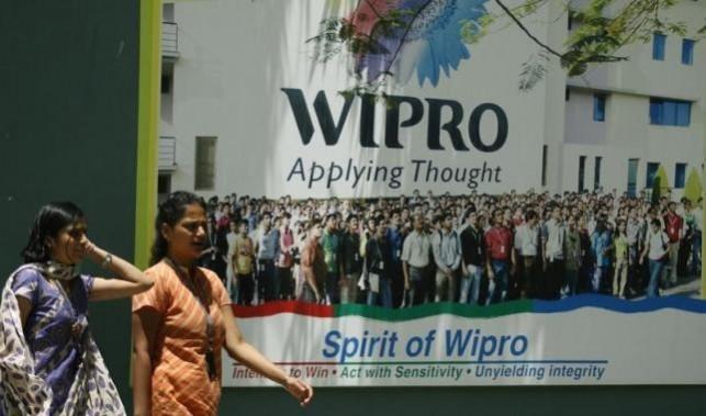 People walk in the Wipro campus in Bangalore June 23, 2009. wipro q3, wipro q3 results, wipro share price, wipro interim dividend, wipro t k kurien retires, wipro it revenues, wipro q4 guidance