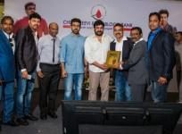 Chiranjeevi and Ram Charan giving mementos to fans