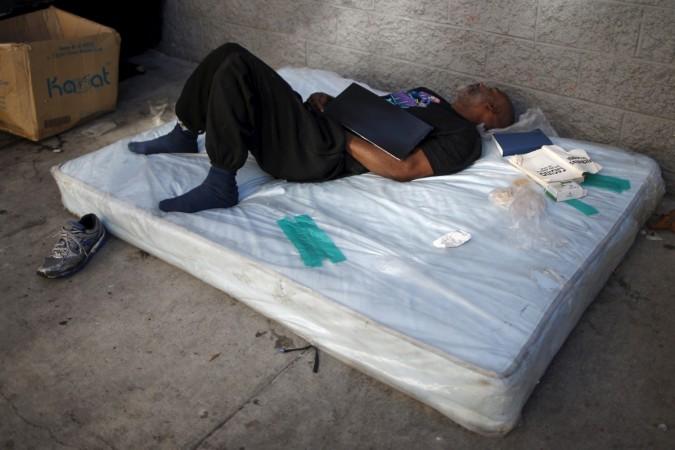 A man sleeps on a matress on Skid Row in downtown Los Angeles