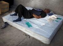 A man sleeps on a matress on Skid Row in downtown Los Angeles