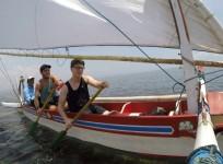 Tyler and Korey rowing a boat to the Pit Stop