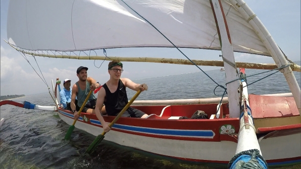 Tyler and Korey rowing a boat to the Pit Stop
