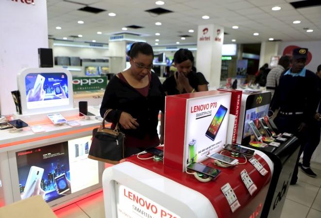 People look at smartphones of Chinese brand Lenovo