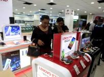 People look at smartphones of Chinese brand Lenovo