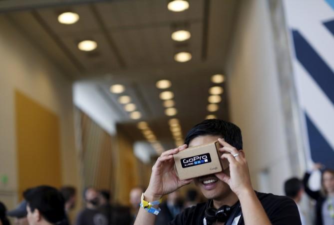A conference attendee looks through "Cardboard," a viewer