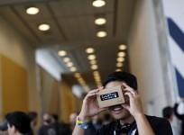 A conference attendee looks through "Cardboard," a viewer