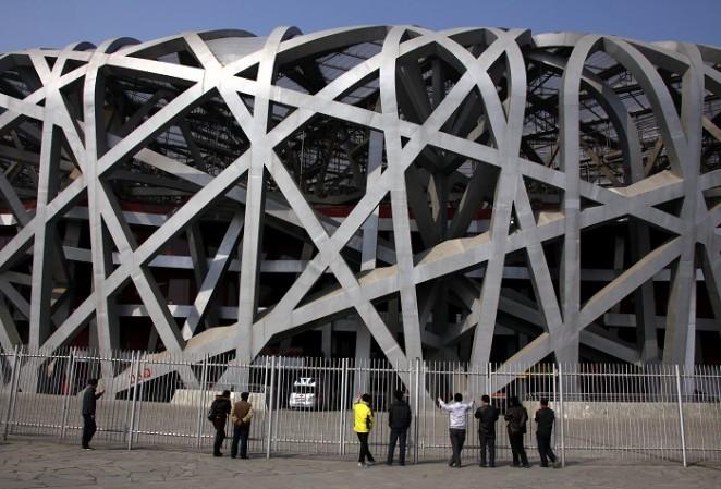 IOC retested 454 samples from Beijing Olympics 2008 using latest techniques. Pictured: Chinese tourists look through a security fence at the National Stadium, also known as the Beijing Olympics 2008