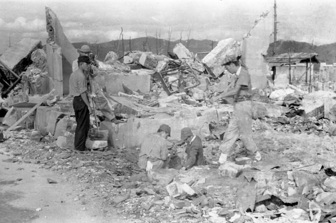 Survey team members measure residual radiation in the ruins of Shima Hospital, located at the hypocenter of the atomic bombing of Hiroshima on August 6, 1945, as Japan Film Corporation staff film them in Saiku-machi district in Hiroshima, Japan, in this handout photo taken by Shigeo Hayashi in October 1945 and released by the Hiroshima Peace Memorial Museum. Hiroshima